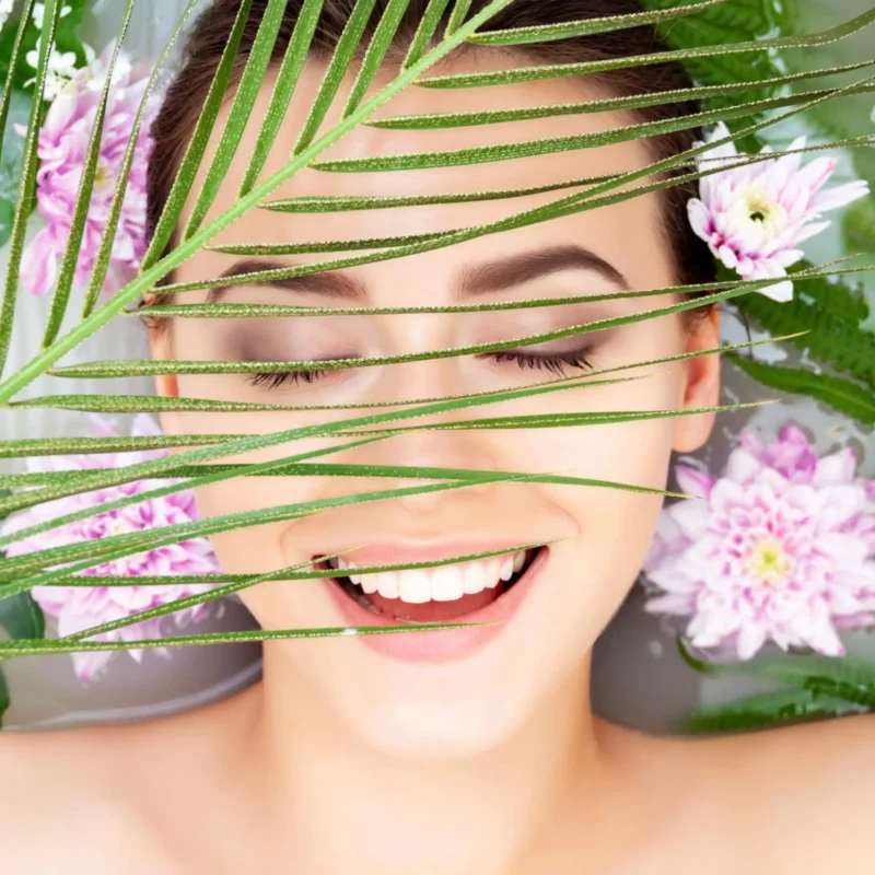 Portrait of young woman relaxing in white spa bath-min